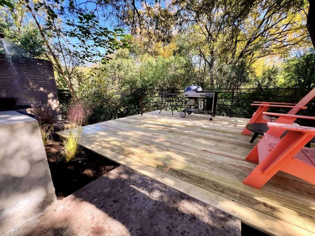 modern hillside deck installation overlooking wooded Dallas backyard