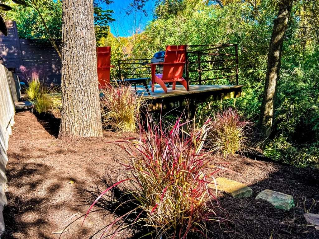 modern hillside deck installation overlooking wooded Dallas backyard