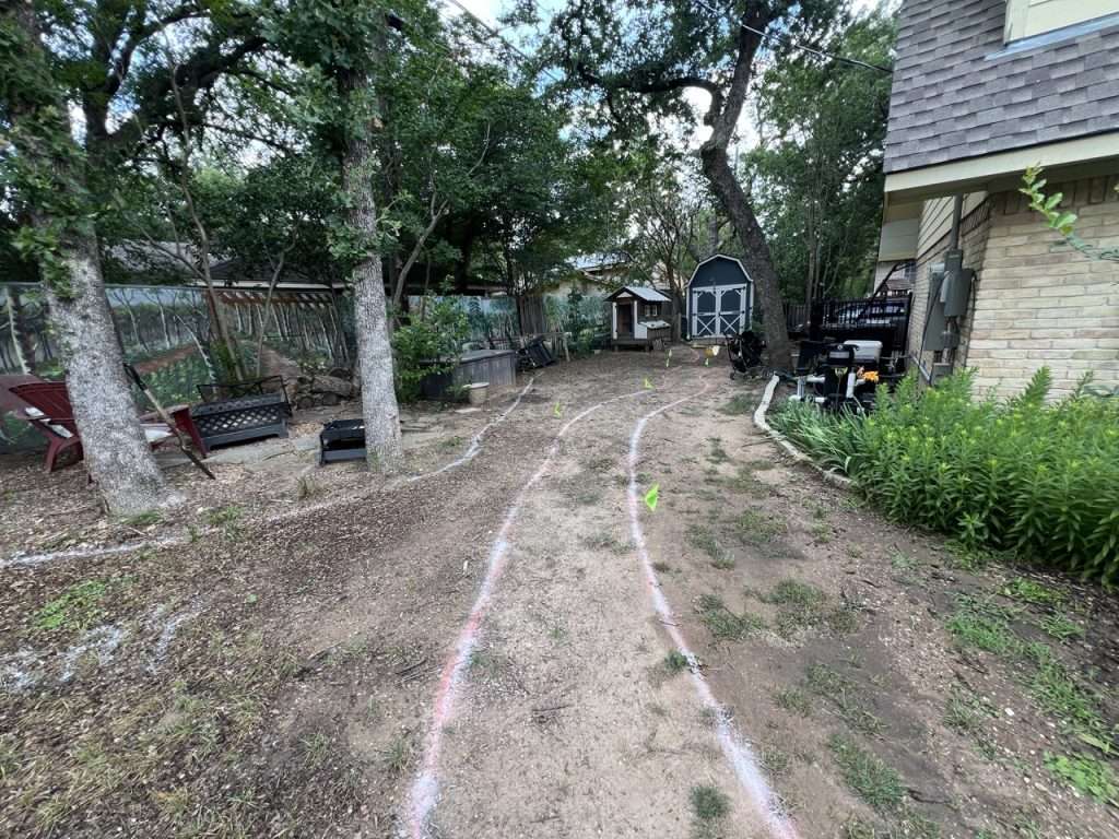 Dallas backyard landscape design marked on site with paint and layout flags